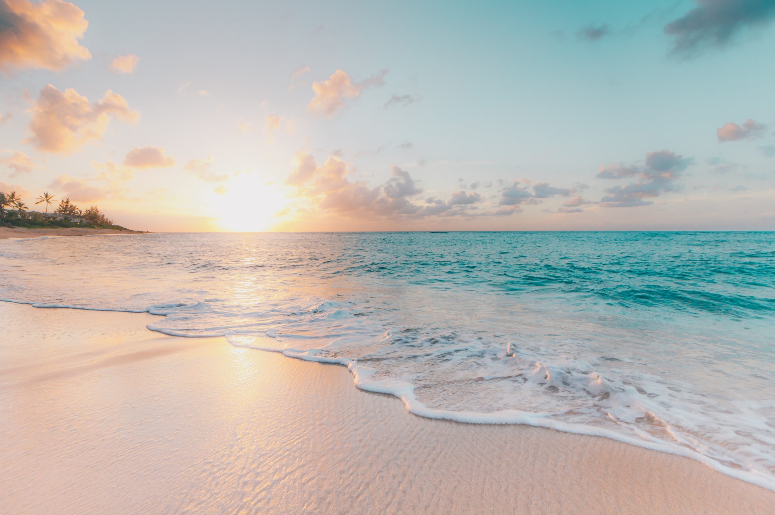 A beautiful sunset photo of a white and sandy beach, depicting the idea of "change."